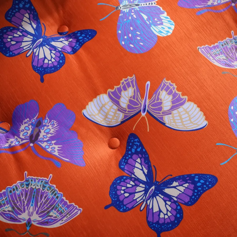 Close-up of custom violet butterfly print on orange fabric