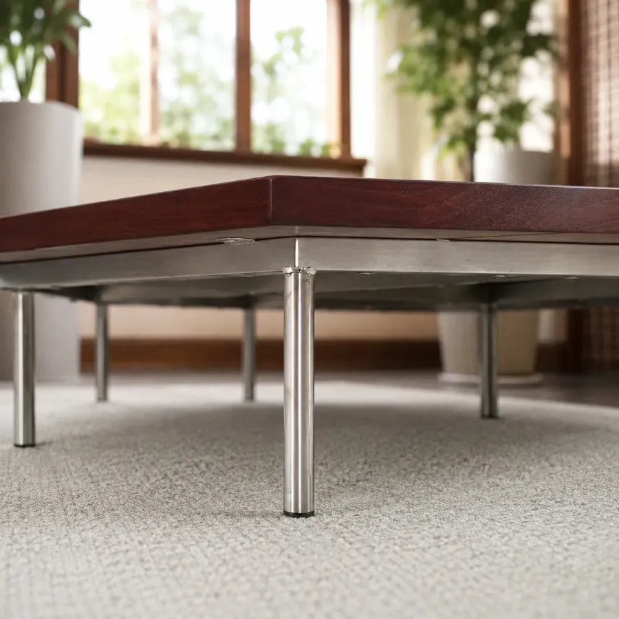 Stainless steel legs under a dark brown Burmese teak base
