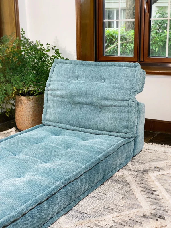 French Mah Jong Daybed Sofa’s tufted backrest and seat with rich teal fabric in a modern home.