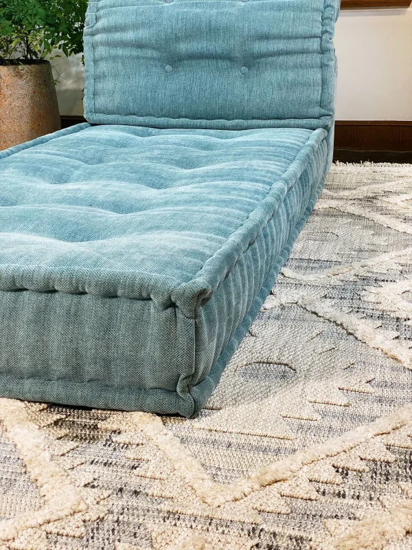 French Mah Jong Daybed Sofa’s corner detailing with textured teal upholstery and firm padding.