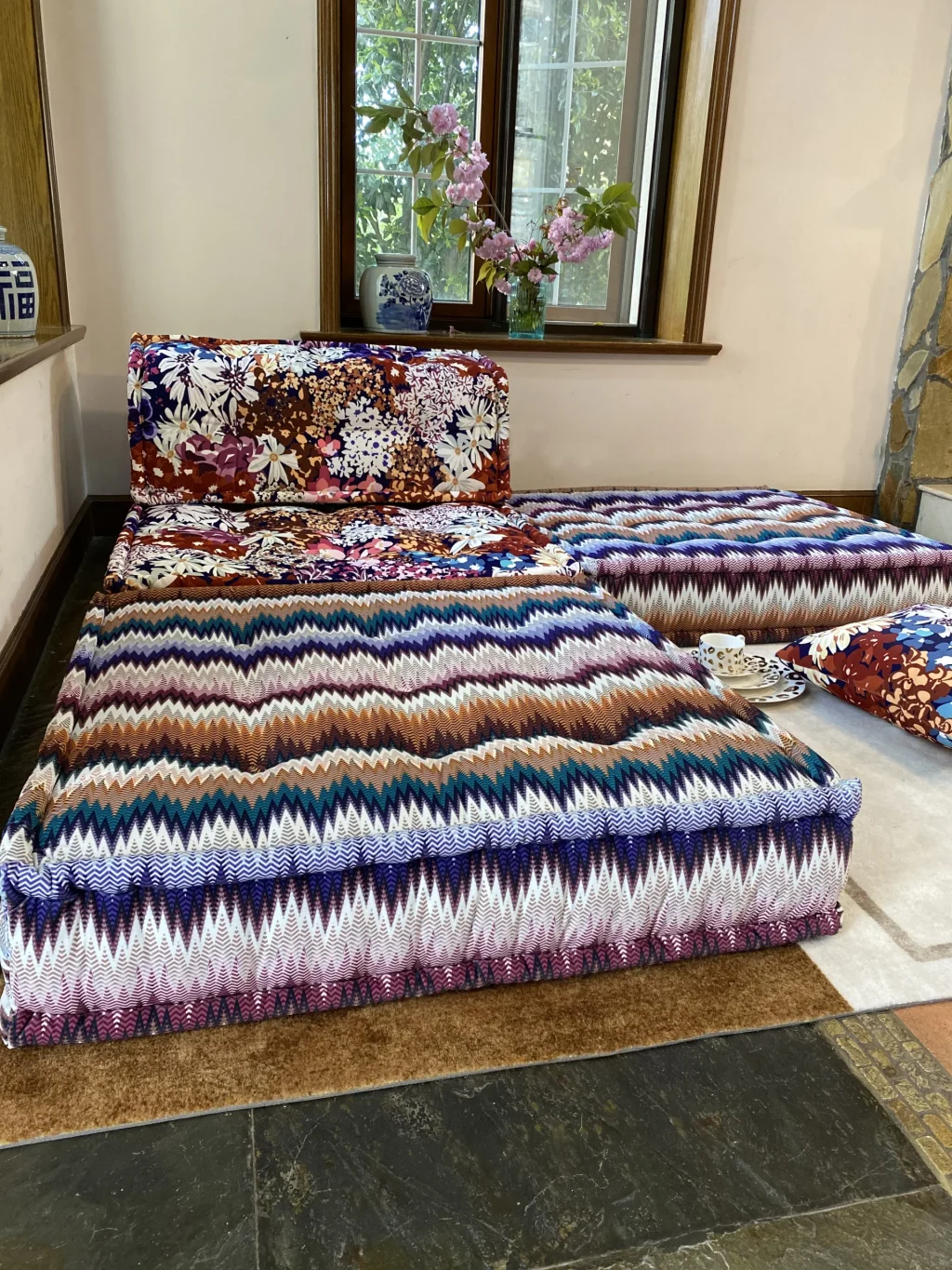 Detailed close-up of floral upholstery on a Mah Jong Sofa with a mix of colors and textures.