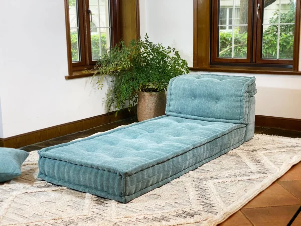 Wide shot of Mah Jong Daybed Sofa in a serene living room with a patterned rug and natural decor.