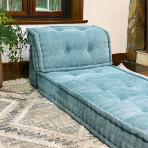 Side angle of a French Mah Jong Daybed Sofa in teal fabric, showcasing its tufted backrest and soft edges.