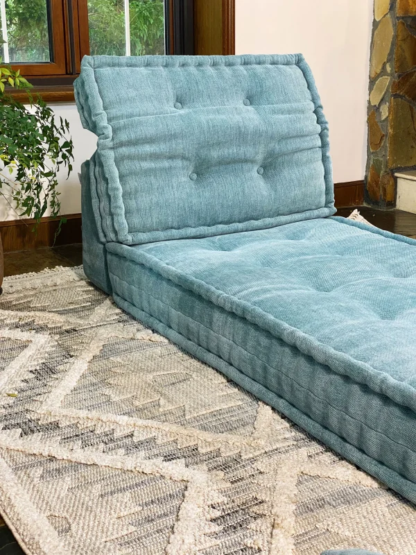 French Mah Jong Daybed Sofa styled in a serene living space with a textured rug and large windows.