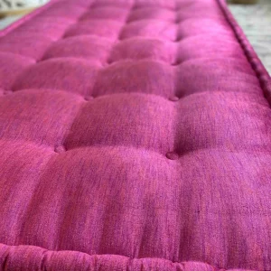 A luxurious pink Mah Jong daybed sofa, styled for comfort and sophistication in a contemporary living room.