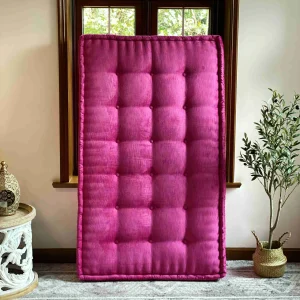 Pink Mah Jong daybed cushion positioned vertically, emphasizing its bold color and elegant tufted details.