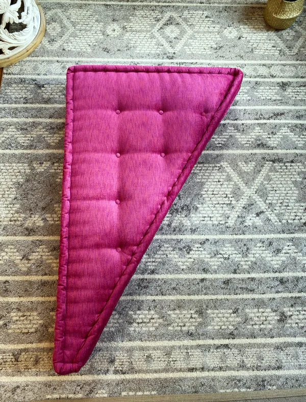 Overhead view of the pink triangular cushion on the French Daybed Mah Jong Sofa, placed on a neutral patterned rug.