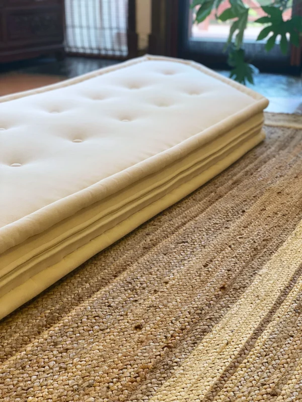 A close view of the tufted surface on the white cushion of the Mah Jong sofa.