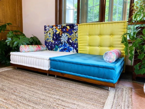 Bright and colorful Mah Jong Sofa arrangement with floral, yellow, and blue elements in a sunny living room.