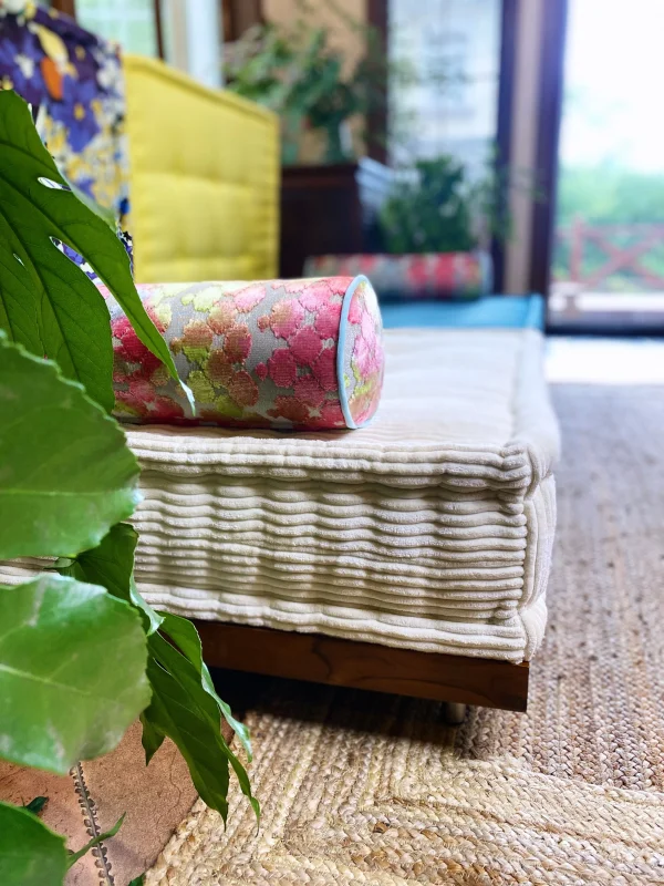 French Daybed Mah Jong Sofa styled with modern floral patterns and vibrant cushions.