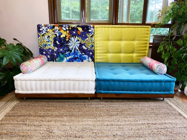 Side view of the French Daybed Mah Jong Sofa with white and yellow cushions.