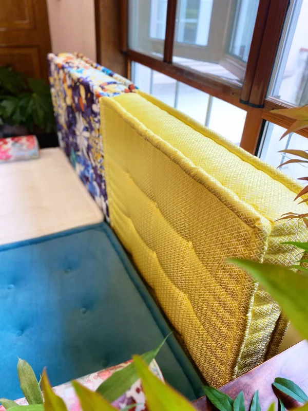 Back view of the French Daybed Mah Jong Sofa showing vibrant floral patterns.