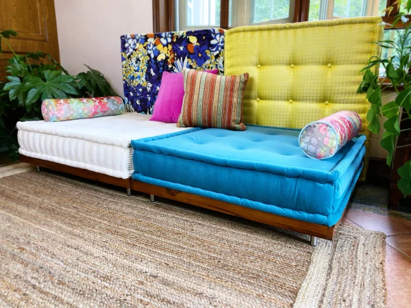 French Daybed Mah Jong Sofa featuring striped and floral decorative cushions.