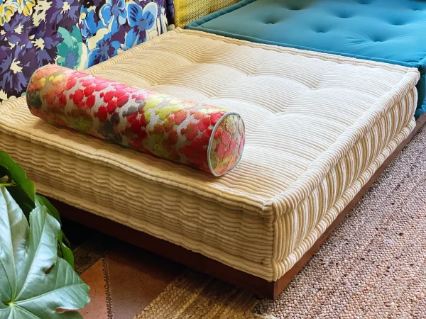 French Daybed Mah Jong Sofa in a bright floral and yellow design, styled with a modern touch.