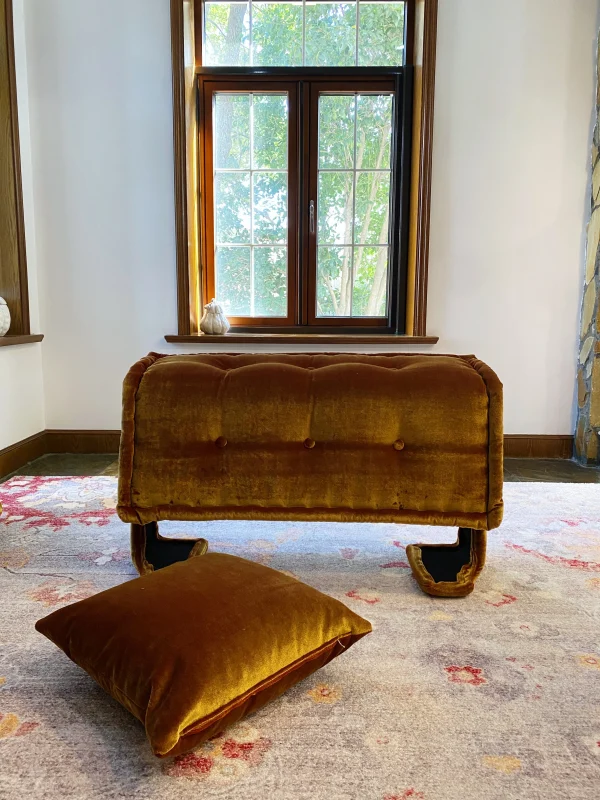 Front view of the French daybed Mah Jong sofa with its golden velvet cover in a compact folded position.