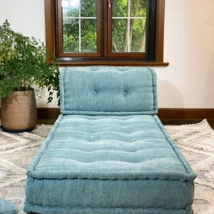 Luxurious French Daybed Mah Jong Sofa in a cozy living room with natural light streaming through the window.