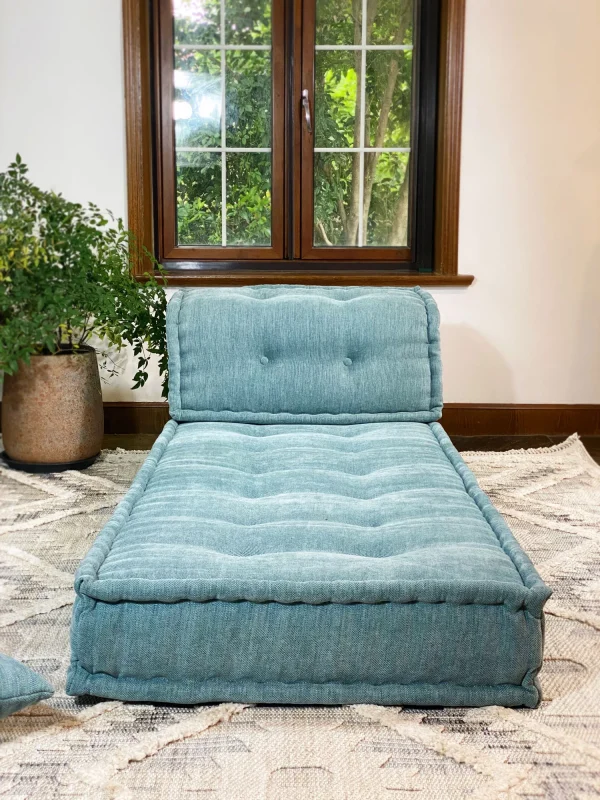 Luxurious French Daybed Mah Jong Sofa in a cozy living room with natural light streaming through the window.