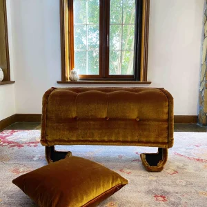 French daybed Mah Jong sofa positioned by a window, folded upright with soft light filtering in.