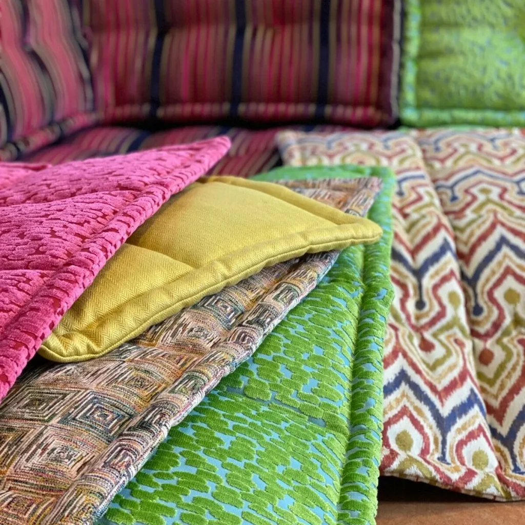 Close-up of vibrant cushions and patterned fabric on the Mah Jong modular sofa.