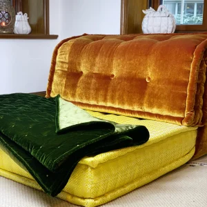 Full view of Mah Jong daybed sofa with velvet upholstery and colorful layered cushions.