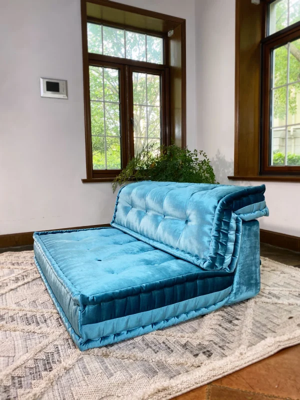 The side view of the French Mah Jong daybed showcases its plush cushions, tufted accents, and vibrant teal velvet. It’s an ideal choice for both modern and bohemian-inspired spaces, providing comfort and style.