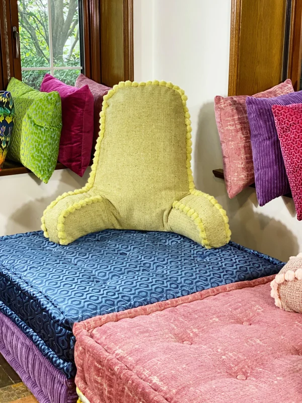 French daybed Mah Jong sofa with a green textured backrest cushion on a patterned blue modular base.