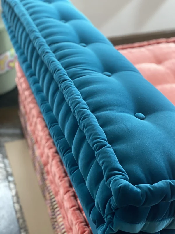 Close-up of blue tufted velvet Mah Jong modular sofa with intricate details.