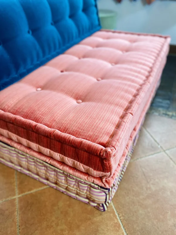 Orange tufted velvet Mah Jong sofa cushion with a focus on texture and softness.