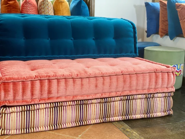 Mah Jong sofa with vibrant modular pieces and colorful throw pillows by a window.