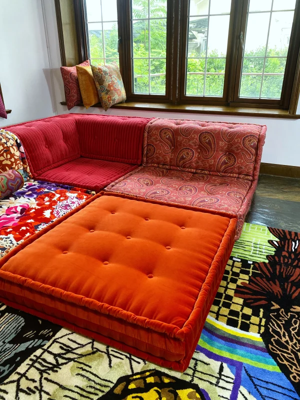 Mah Jong sectional sofa with a mix of textures, including red corduroy and printed patterns.