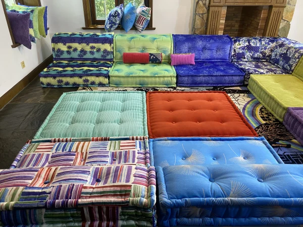 Center mats of the Mah Jong sofa in red and blue hues with striped patterns.