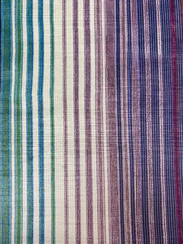 Close-up view of a multi-colored striped fabric with green, purple, and blue hues, showcasing a gradient pattern.