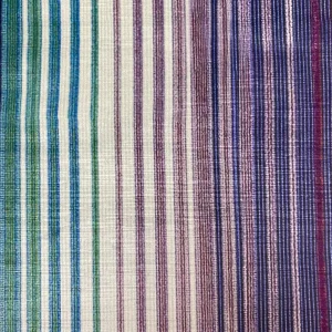 Close-up view of a multi-colored striped fabric with green, purple, and blue hues, showcasing a gradient pattern.