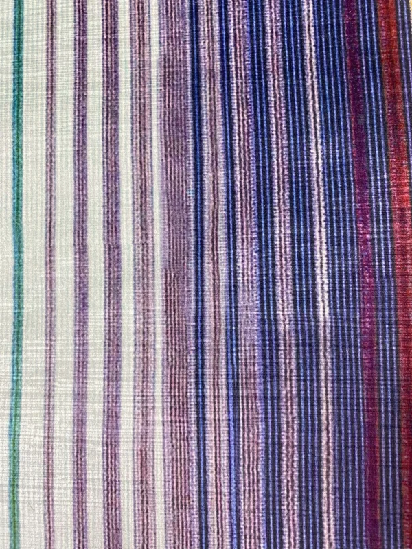 Close-up view of a multi-colored striped fabric with purple, blue, and red hues, showcasing a gradient pattern.