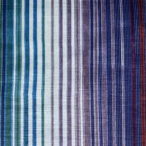 Close-up view of a multi-colored striped fabric with green, purple, and blue hues, showcasing a gradient pattern.