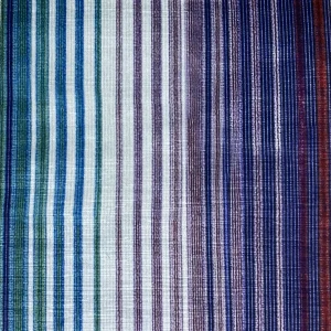 Close-up view of a multi-colored striped fabric with green, purple, and blue hues, showcasing a gradient pattern.