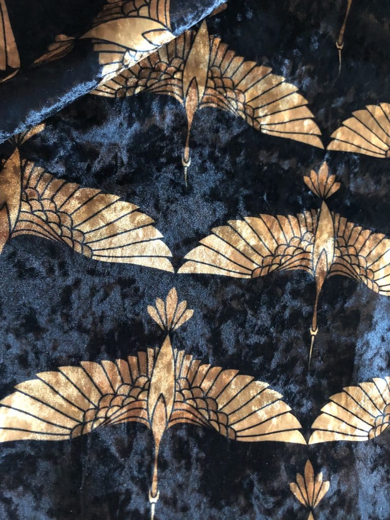 Black crushed velvet fabric with a gold art deco crane pattern, the customer's own material