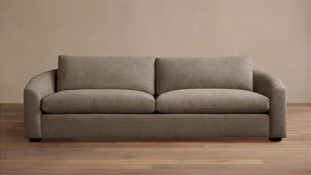 Arhaus custom sofa with soft gray upholstery in a modern, light-filled living space.