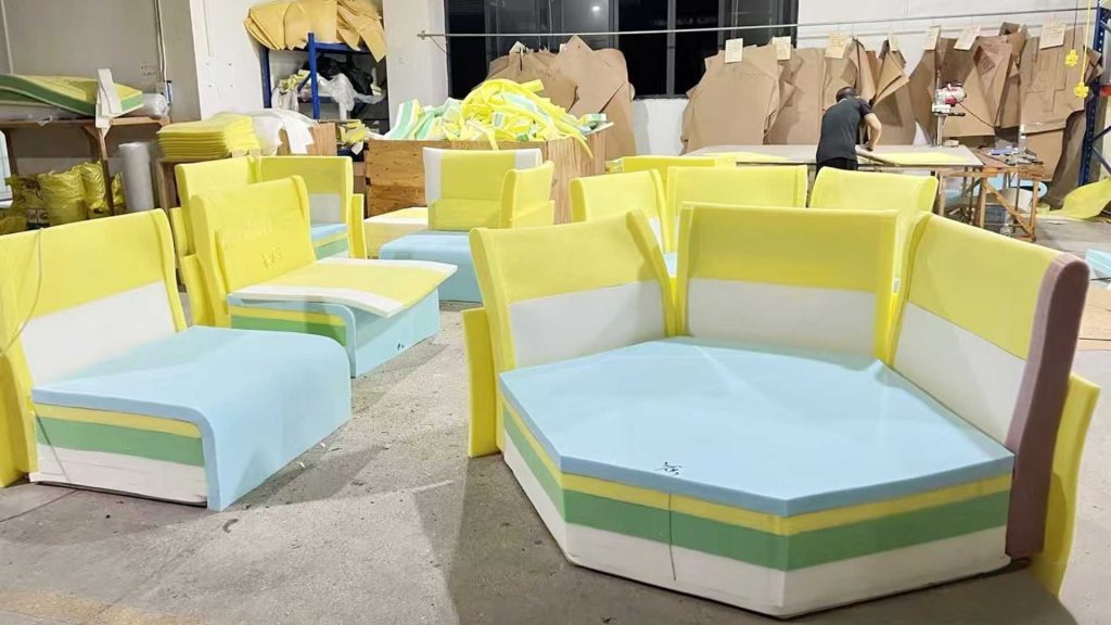 Cushion layers of several sofas in a workshop.