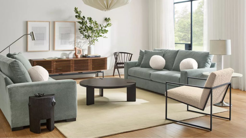 Room & Board custom sofa in green fabric styled in a bright, modern living room.