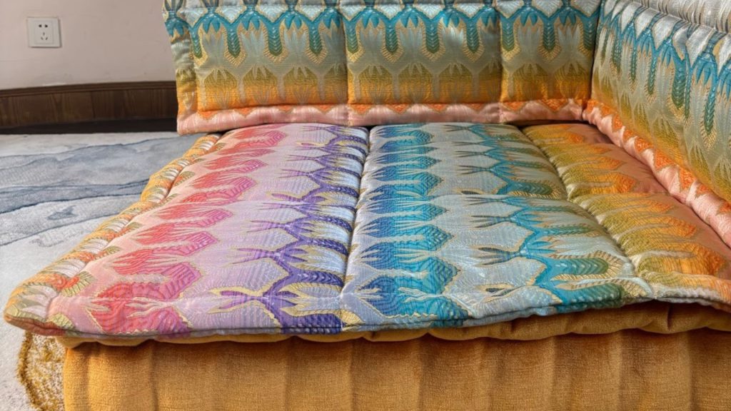 Close-up of a colorful sofa topper.