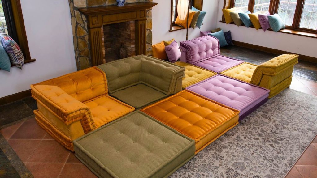Colorful modular sofa styled with a mix of pillows that complements the sofa's color.