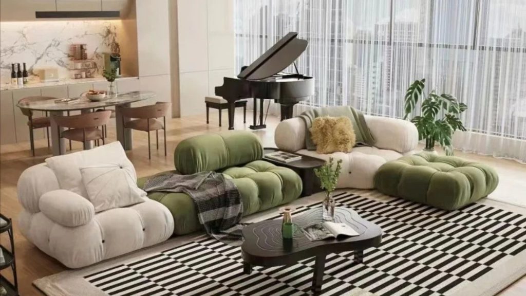 Open-concept living room where an L-shaped sofa is placed opposite of a dining table and piano.