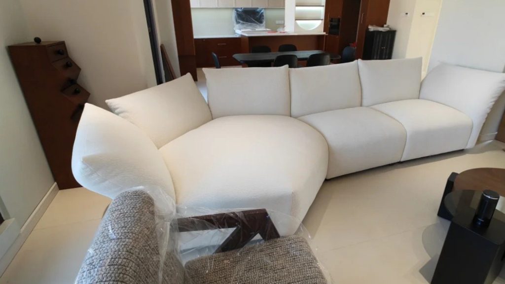 White petal sofa blocking the entryway of a living room.