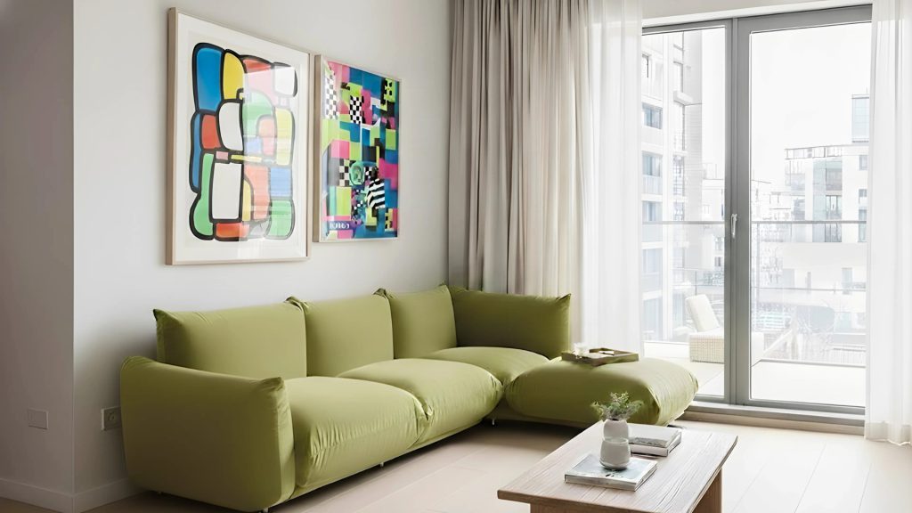 Small apartment living room with a green L-shaped Marenco sofa.