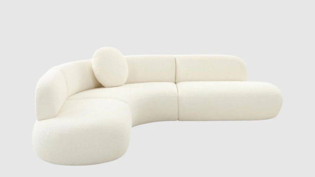 Living Space's Broohah Curved Sectional in cream white bouclé fabric.
