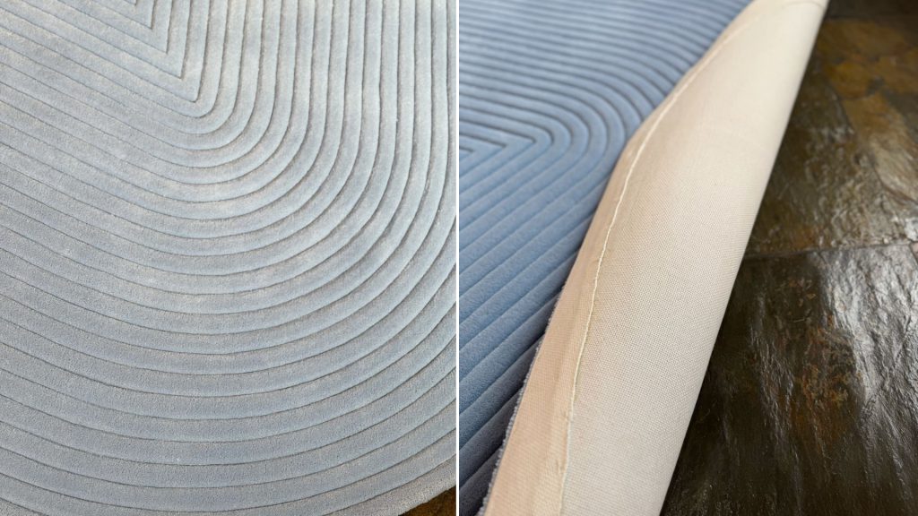 Closeup of a rug in blue with expert detailing on the left and the bottom of the rug on the right.