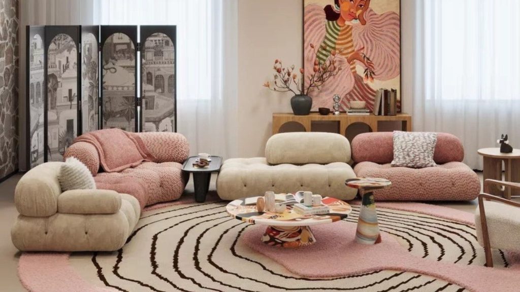 Pink and white designer sofas in a modern-looking living room with contemporary art.
