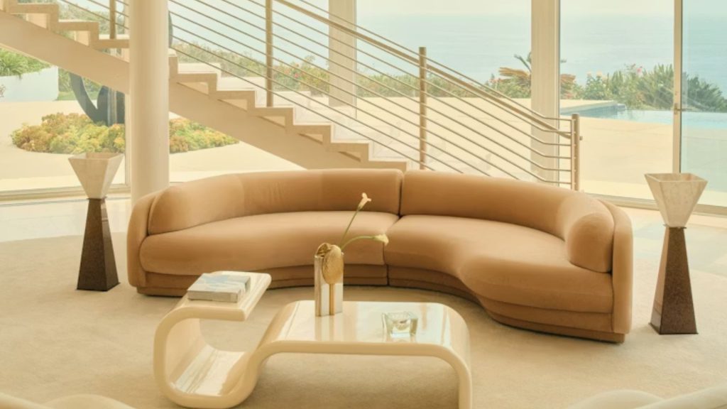 Design Within Reach’s Poet Sofa in a large living room with a staircase.