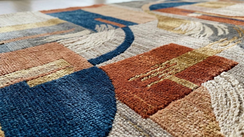 A closeup image of an art silk rug with multiple patterns.